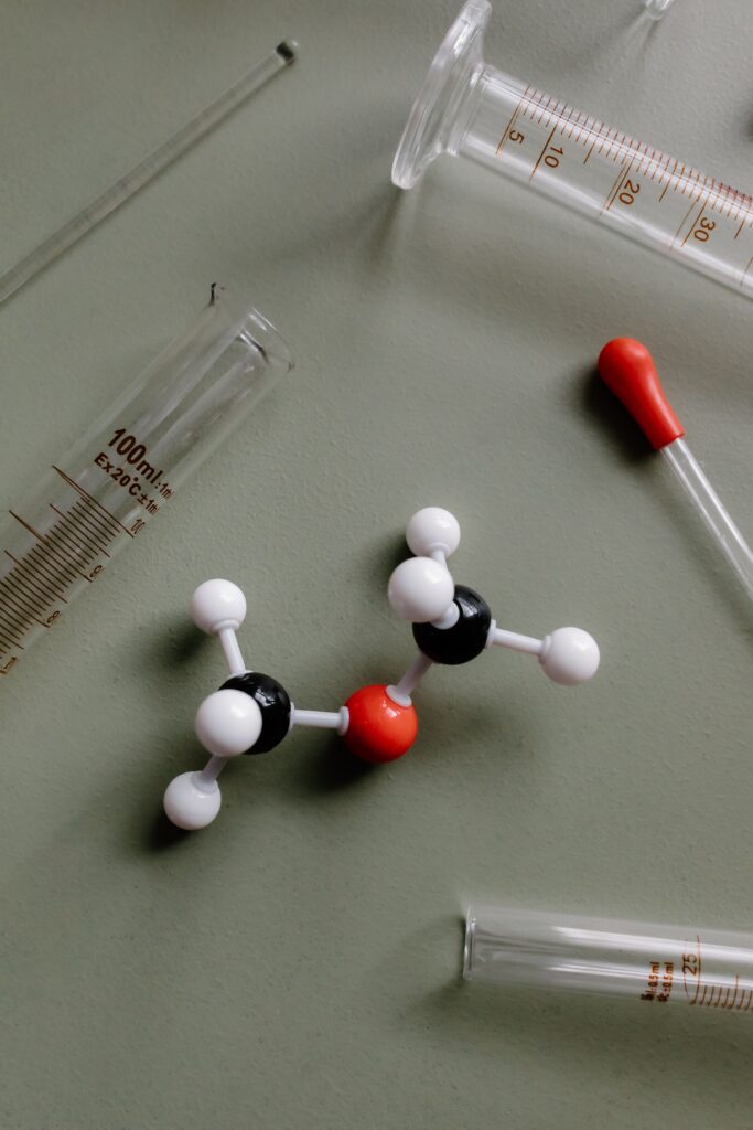 syringes and plastic figures of chemical chains