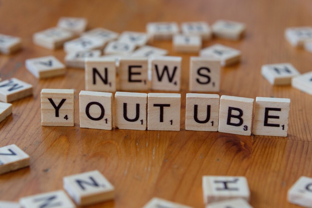 Scrabble letters spelling news and youtube