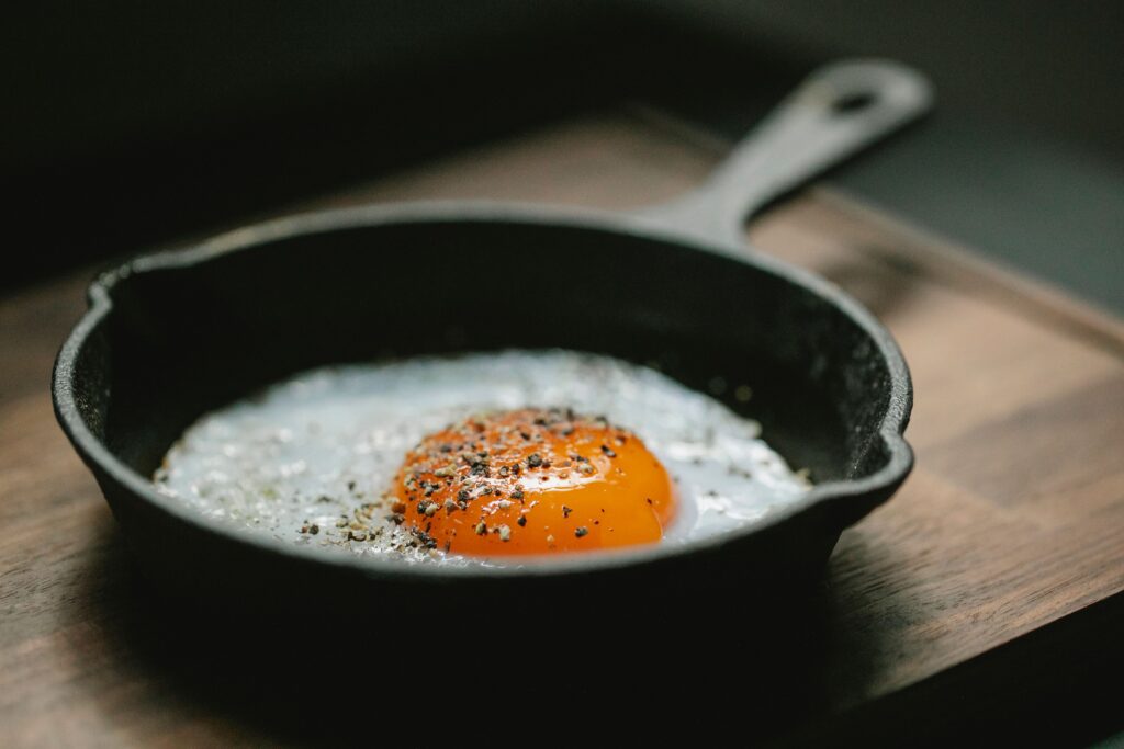 egg cooking in cast iron pan